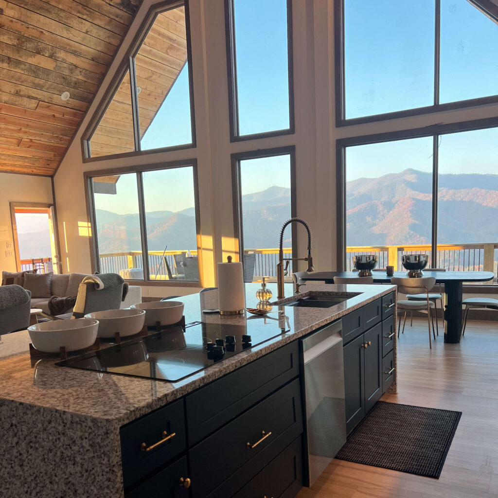 View of inside a Grand View Falls home, with large window wall with mountain view